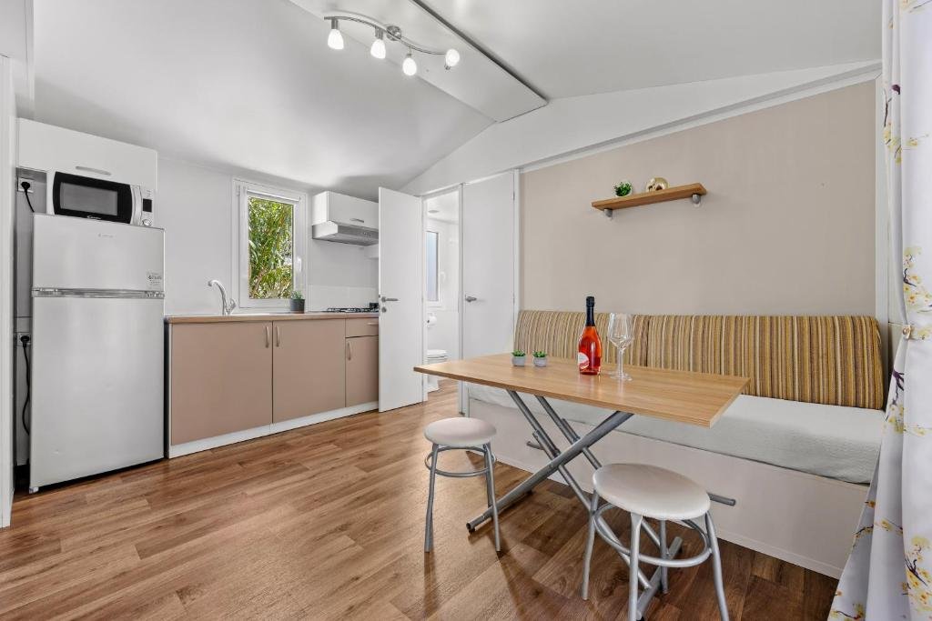 Living area with kitchen, dining table and corner sofa