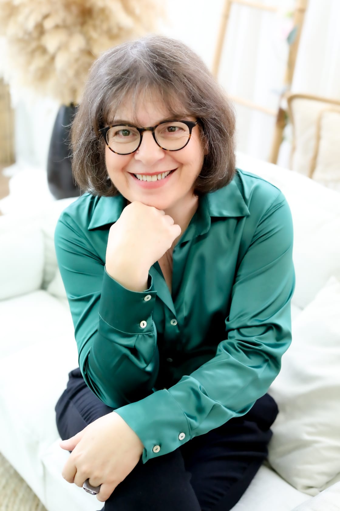 Michal Maor, Longevity tribe co-leader, smiling in a green silk blouse